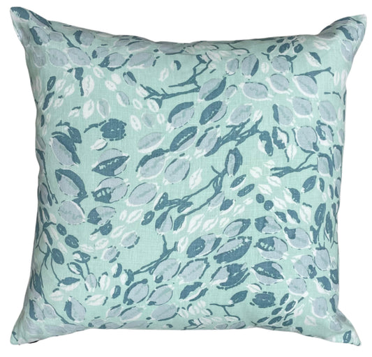 Decorative pillow with floral pattern on a light blue background